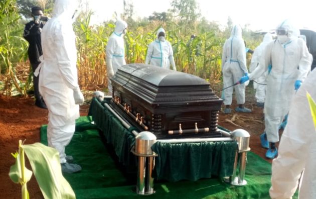Casket bearing the remain of Papa Shirandula is sprayed before being lowered into the grave